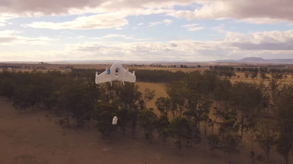 The drones were shown in a promotional video to hover above treelines and lower packages to the ground on some form of cable