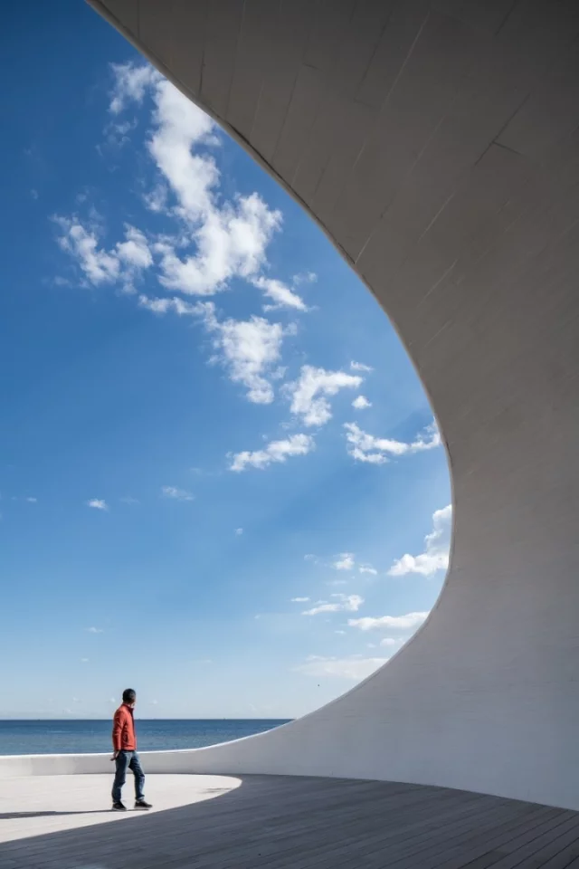 The UCCA Dune Art Museum features a spiral staircase that leads upwards to a viewing platform where visitors can take in views of the Bohai Sea
