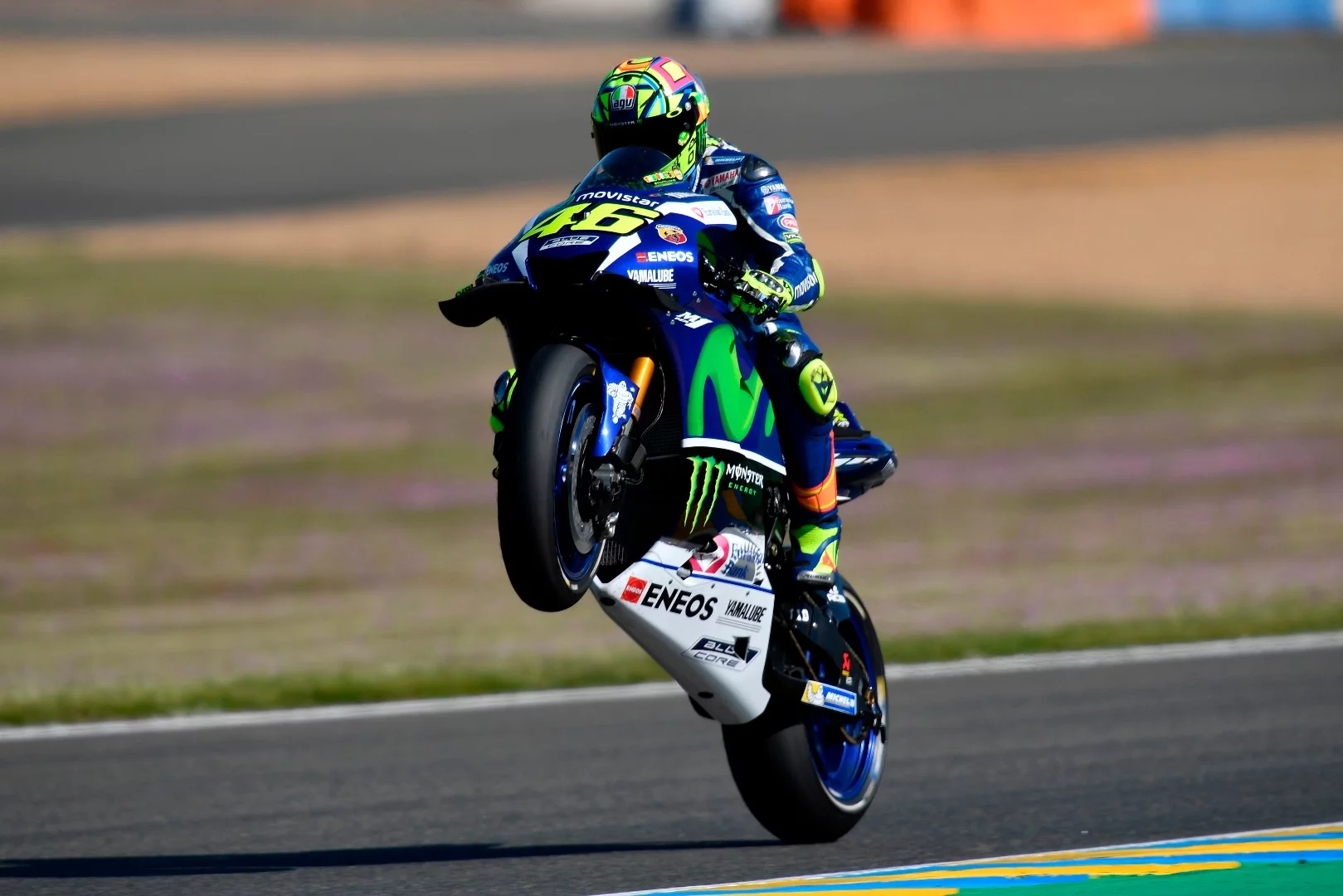 Wrestling with a 280-hp, 157-kg monster occasionally means that not even wings can keep it from attempting to fly, as Valentino Rossi displays here on his Yamaha M1