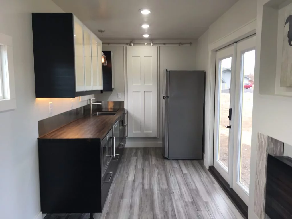 The Intellectual Tiny Home's kitchen includes plenty of cabinet space