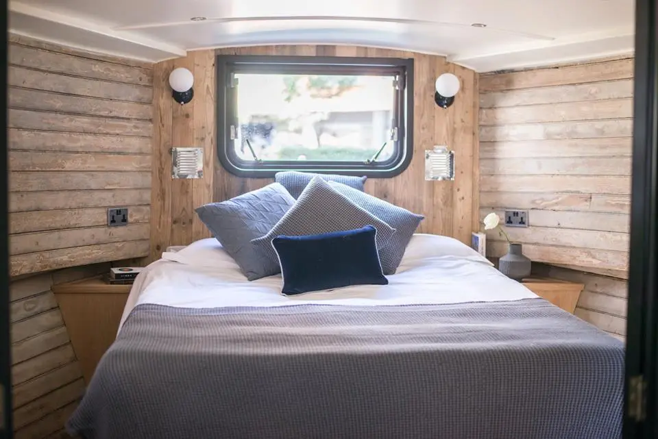 The Boathouse London features a private double bedroom with plenty of reclaimed wooden panelling