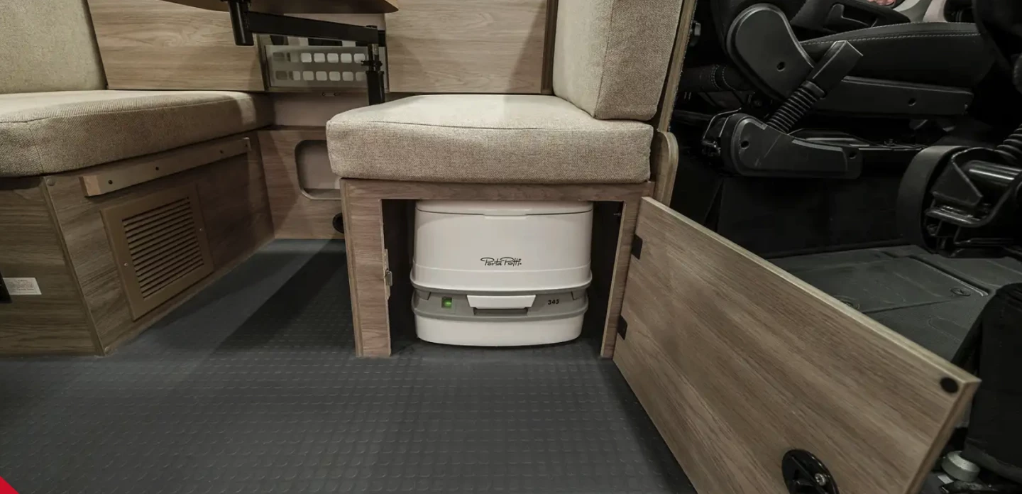 Beyond being a sofa, daybed, spare bed and dining area, the multipurpose lounge has one more trick: a hidden portable toilet