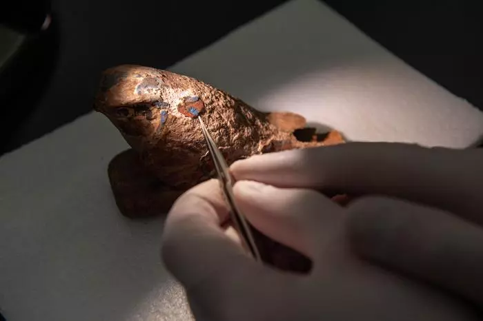 Closeup image of an ancient wooden Egyptian falcon. Researchers have found a way to reproduce the blue pigment visible on the artifact, which is the world's oldest synthetic pigment.
