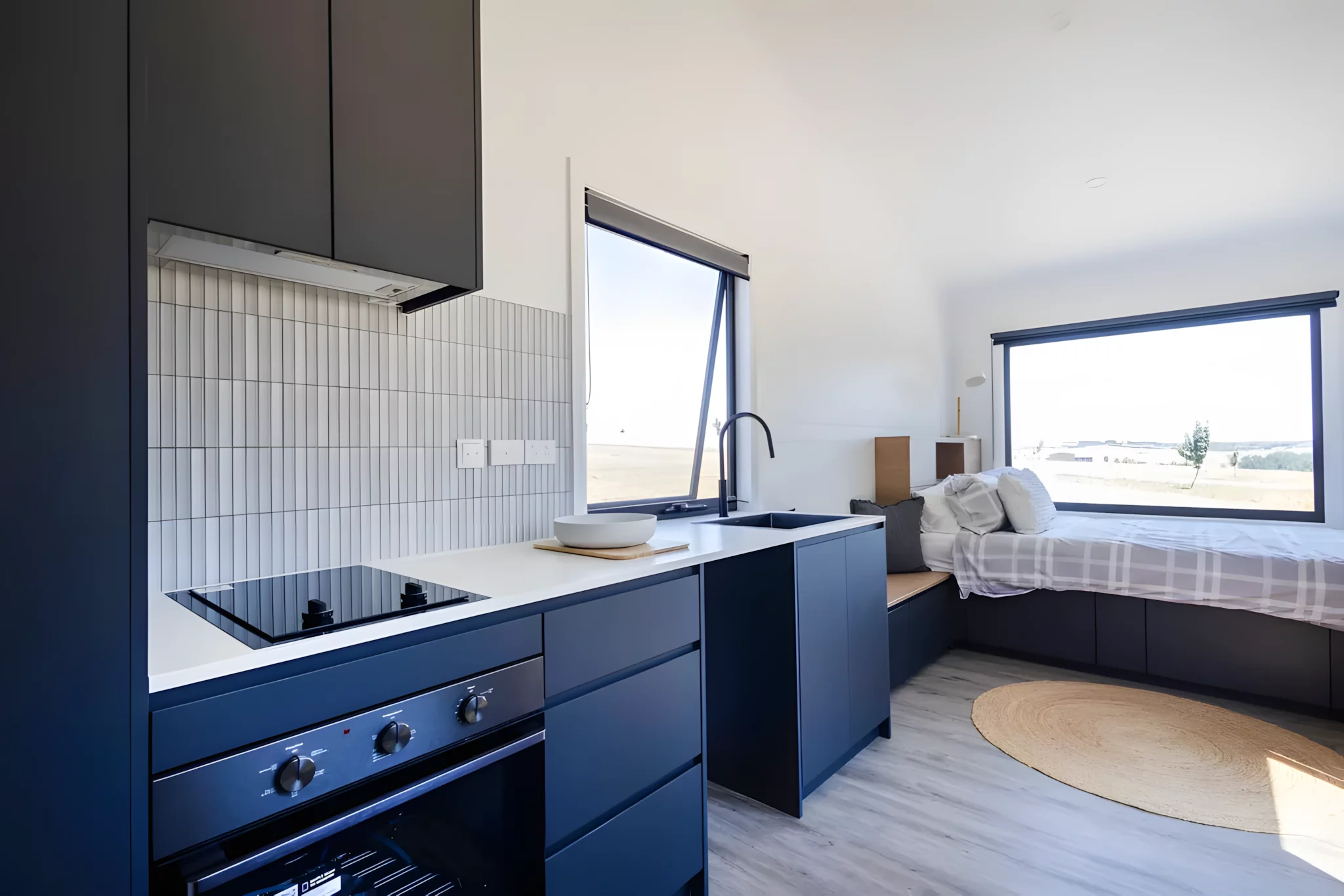 The Audrey's kitchen includes an oven and induction cooktop, a sink, and space for more appliances to be installed