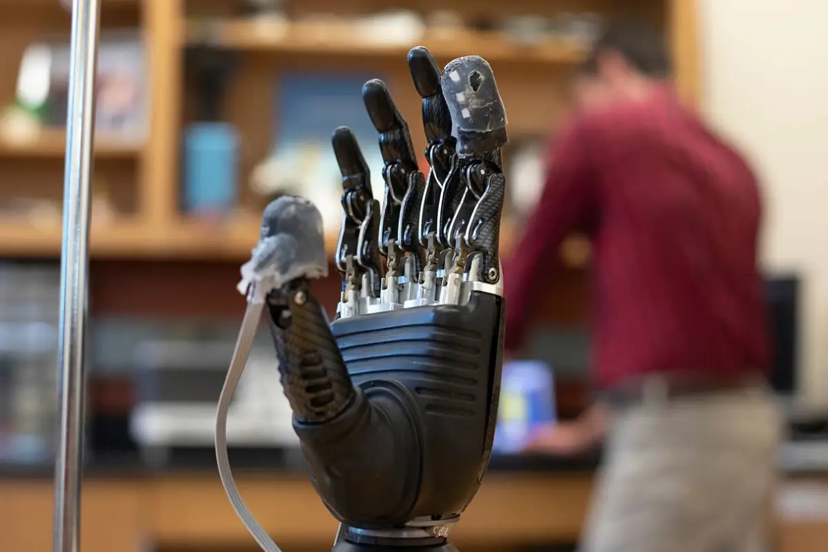 The "e-dermis" applied to the thumb and forefinger of a prosthetic hand