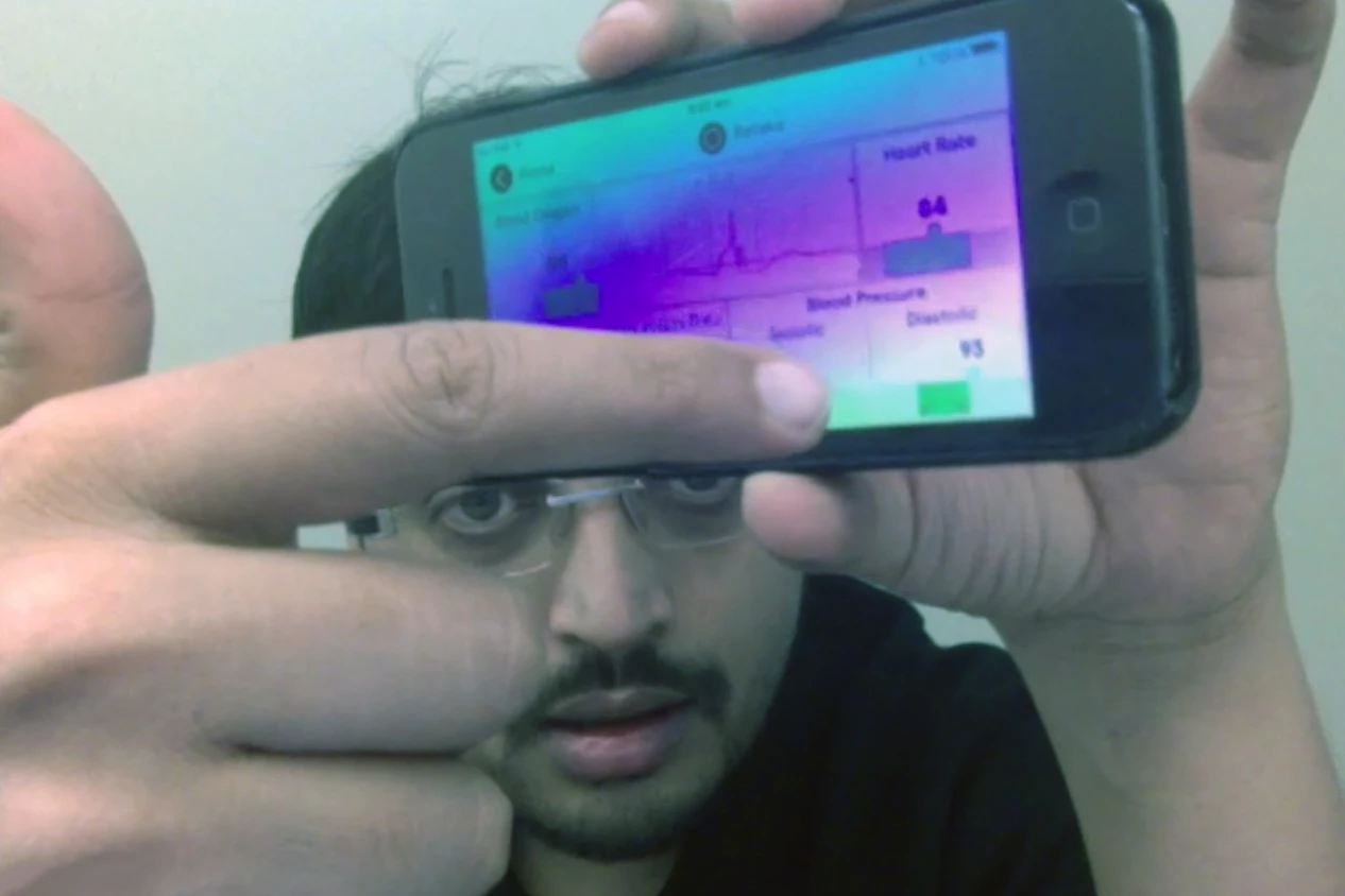 Hamish Patel demonstrates the Wello health monitoring iPhone case