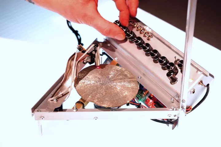 A custom laser scanner reads the pyrite sun's surface irregularities and the data is transformed into digital sounds