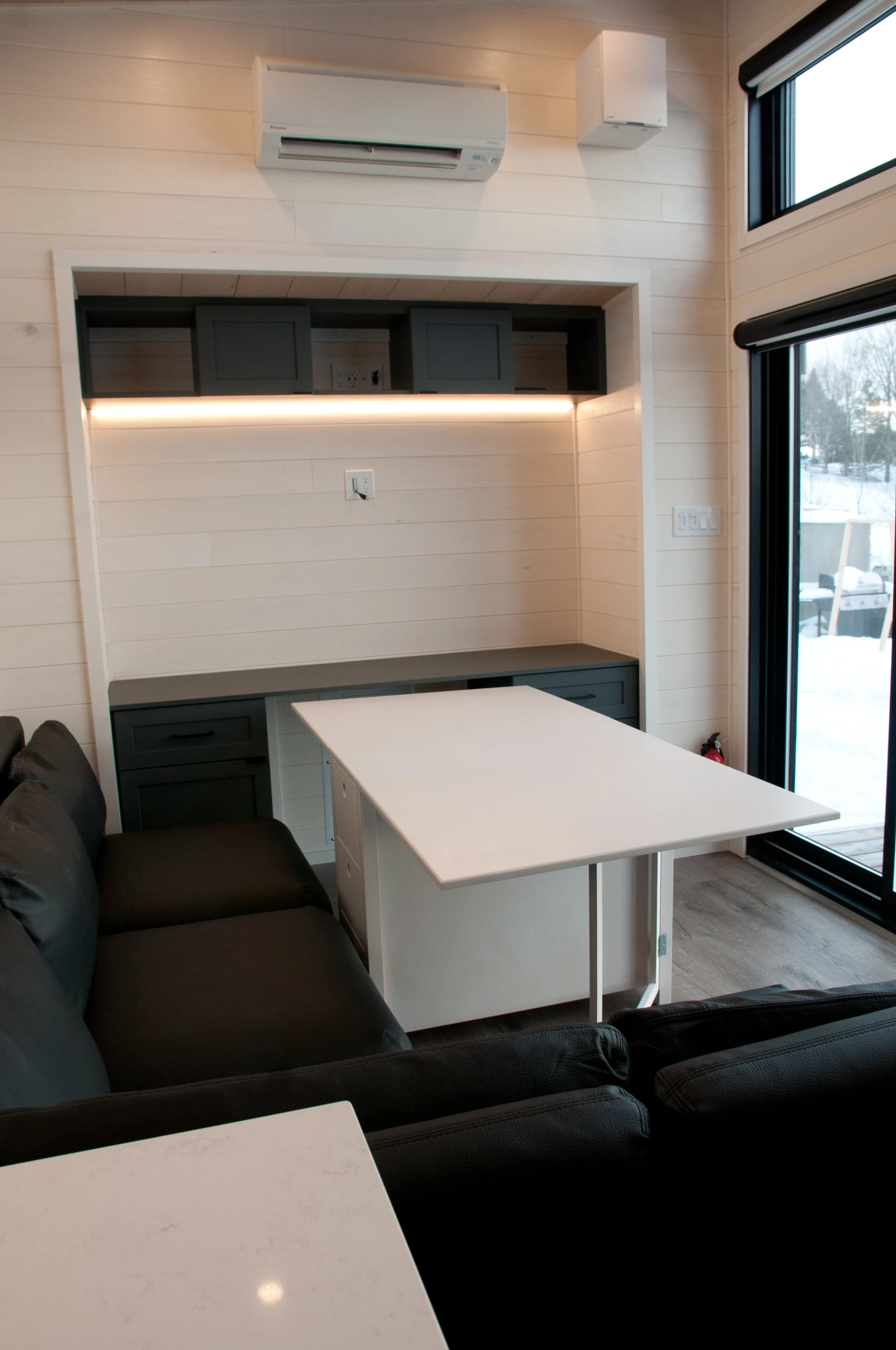 The Magnolia V7's living room includes a folding dining table that stows away when not in use