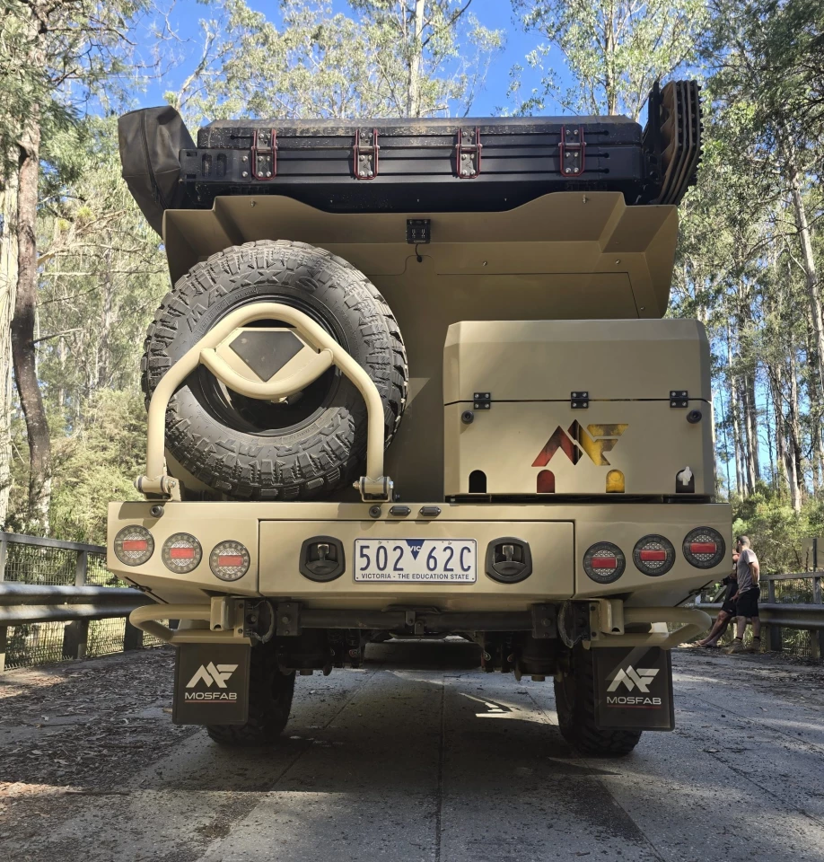 The rear of the trailer includes an under-body storage drawer, jerry can/firewood box and swing-down spare tire carrier