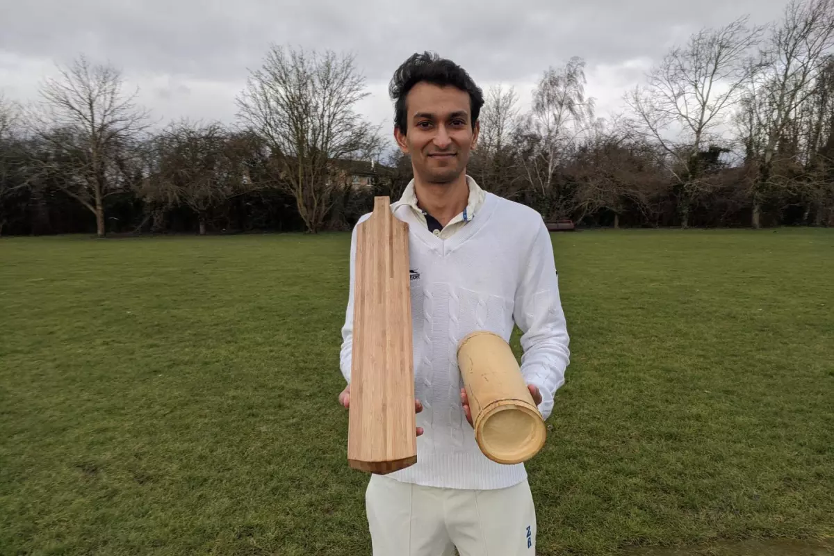 Dr. Darshil Shah with one of the prototype bamboo cricket bats and a length of the bamboo used to make it