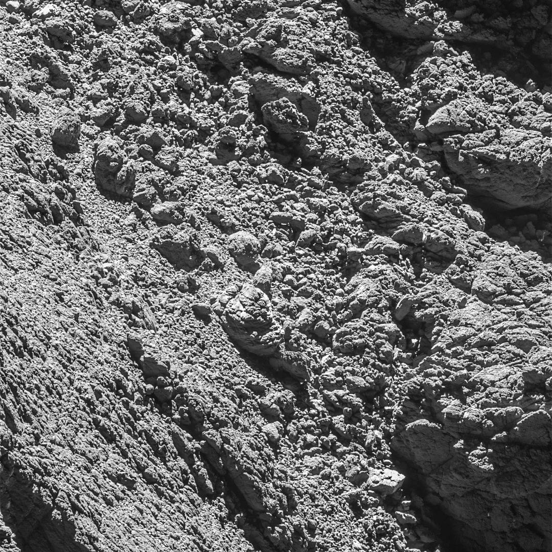 The comet surface with Philae located at the far right of the image, just above centre