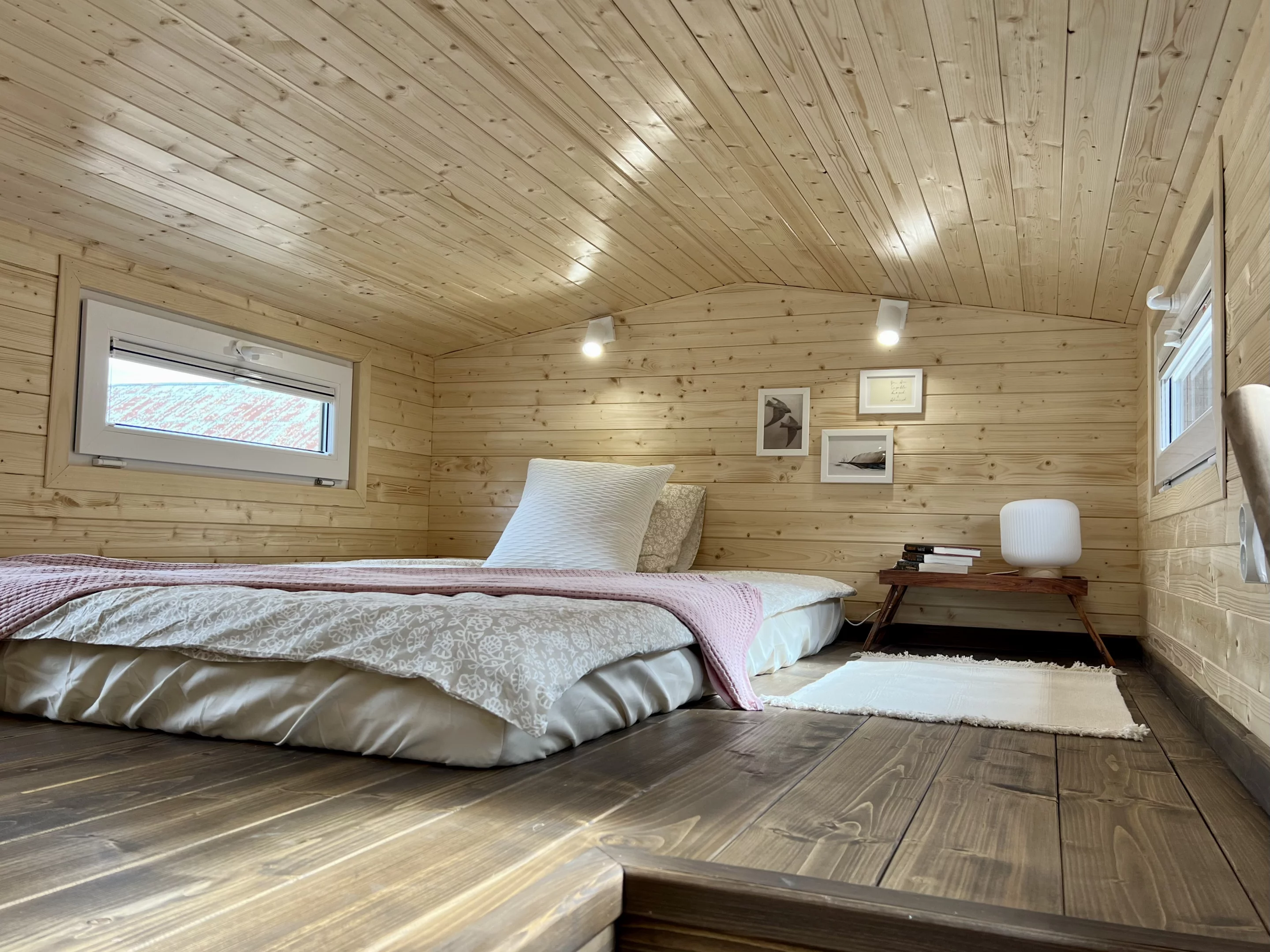 The Sunshine tiny house's bedroom is a typical loft-style tiny house bedroom with a low ceiling