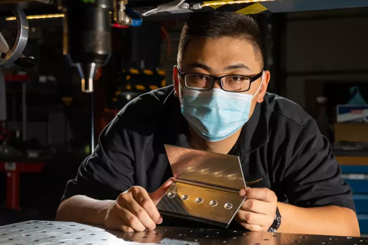 Dr. Tianhao Wang with an RHR-riveted sample of magnesium