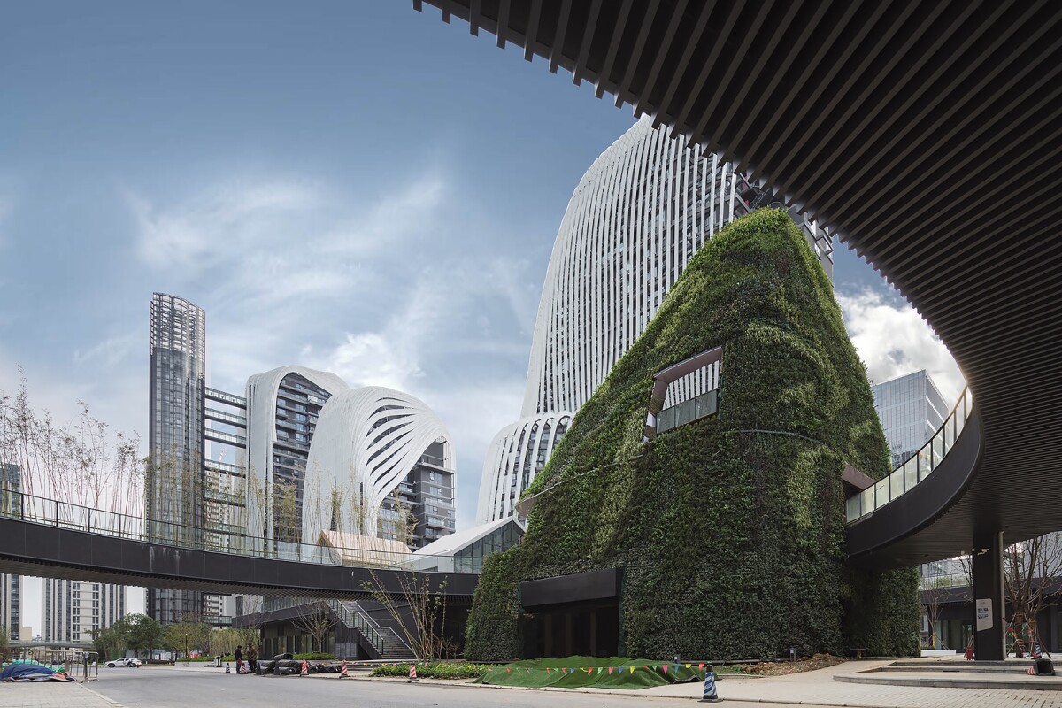 The Nanjing Zendai Himalayas Center's pedestrian bridges and footpaths wind through the landscaping that includes waterfalls, ponds, and pools, as well as trees and other greenery