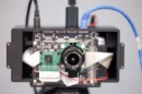PrivacyLens captures standard digital video with the round lens, while the square lens senses heat