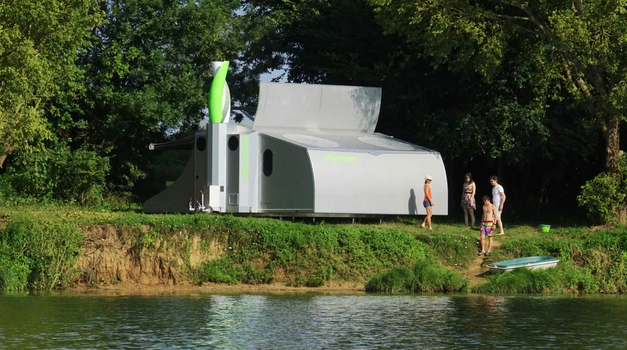 The gray and green wind turbine provides an alternative to the solar panels