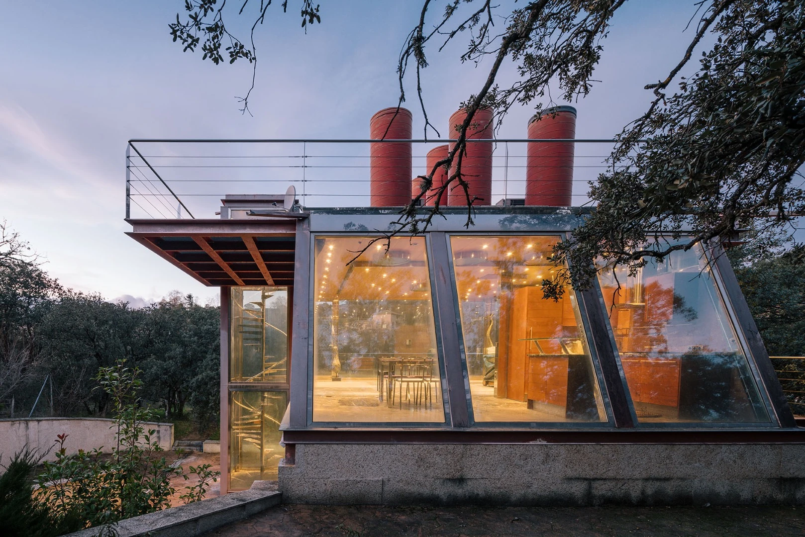 The Hidden Pavilion's unusual shape is informed by the need to not disturb the existing trees on the plot, including a 200 year old holm oak tree