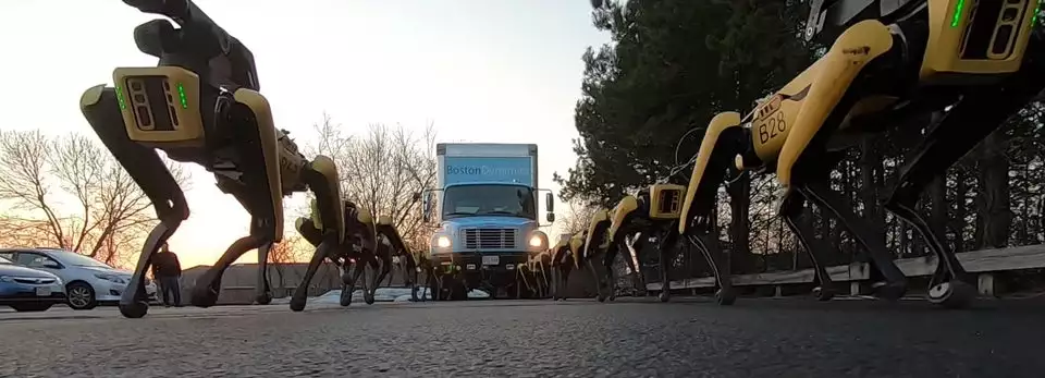 Ten SpotMini bots pull a small truck