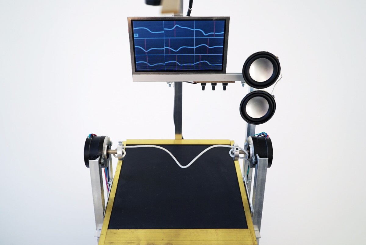 The volnovod's two stepper motors twist and turn the cable below a digital camera