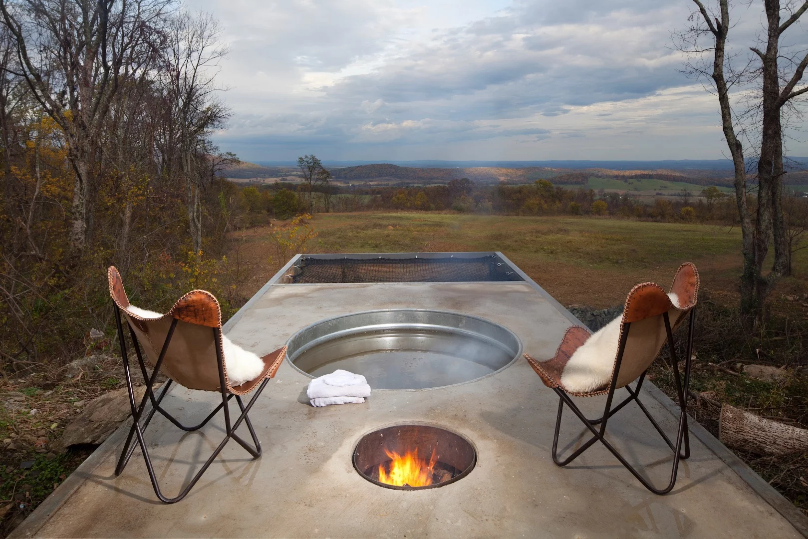 The Lost Whisky Concrete Cabin's deck includes a wood-fired hot tub and net hammock