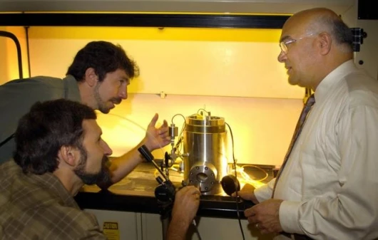 Purdue engineers adjust a test chamber used in research to develop a new way of producing hydrogen for fuel cells to automatically recharge batteries in portable electronics, such as notebook computers, an approach that could eliminate the need to use a w