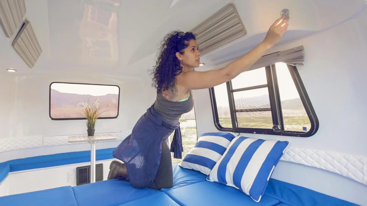 The Happier Camper HC1 travel trailer has large windows and interior lighting
