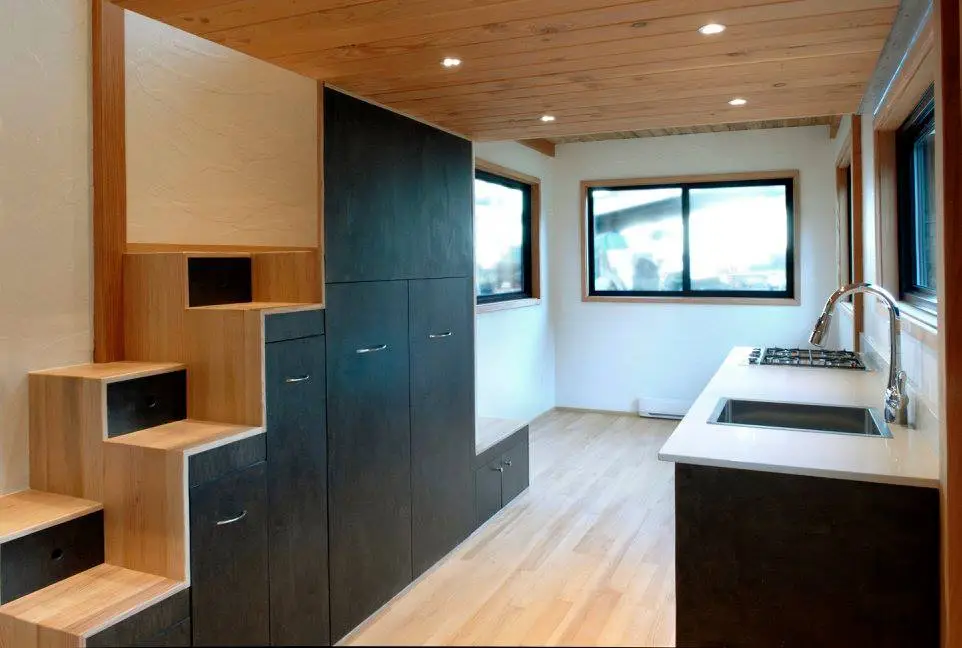 The staircase (with integrated storage) leads to a small upstairs loft