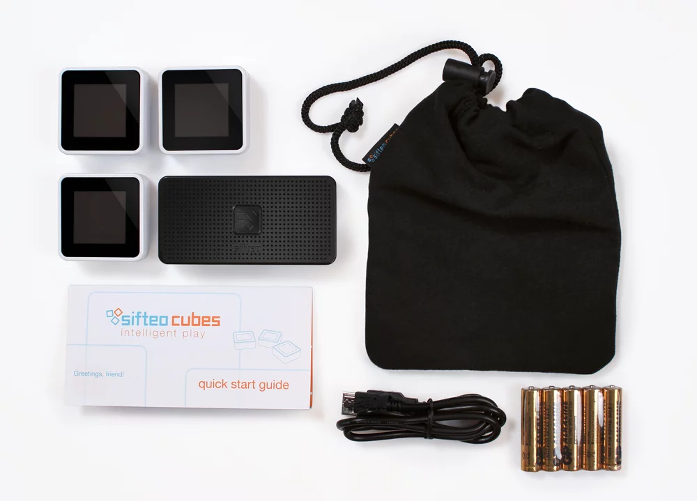 A next generation Sifto Cubes system consists of three blocks, a new Sifteo Base, some batteries, a mini USB cable and a soft case