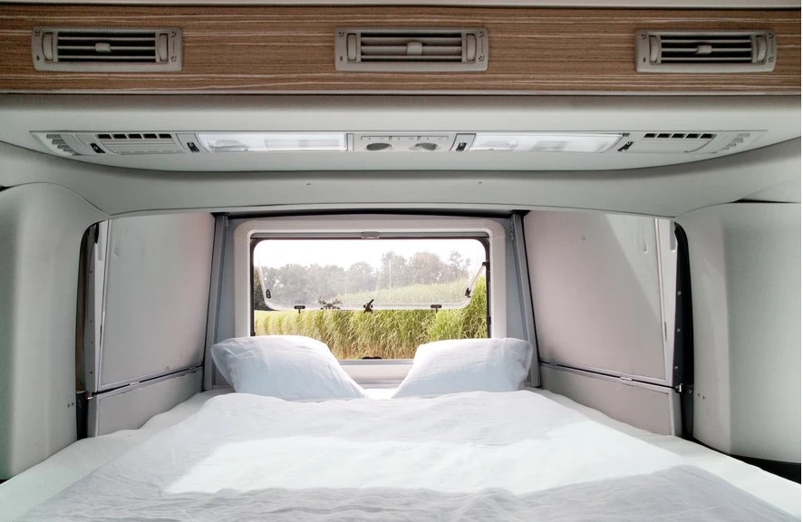The slide-out bedroom has a large rear window