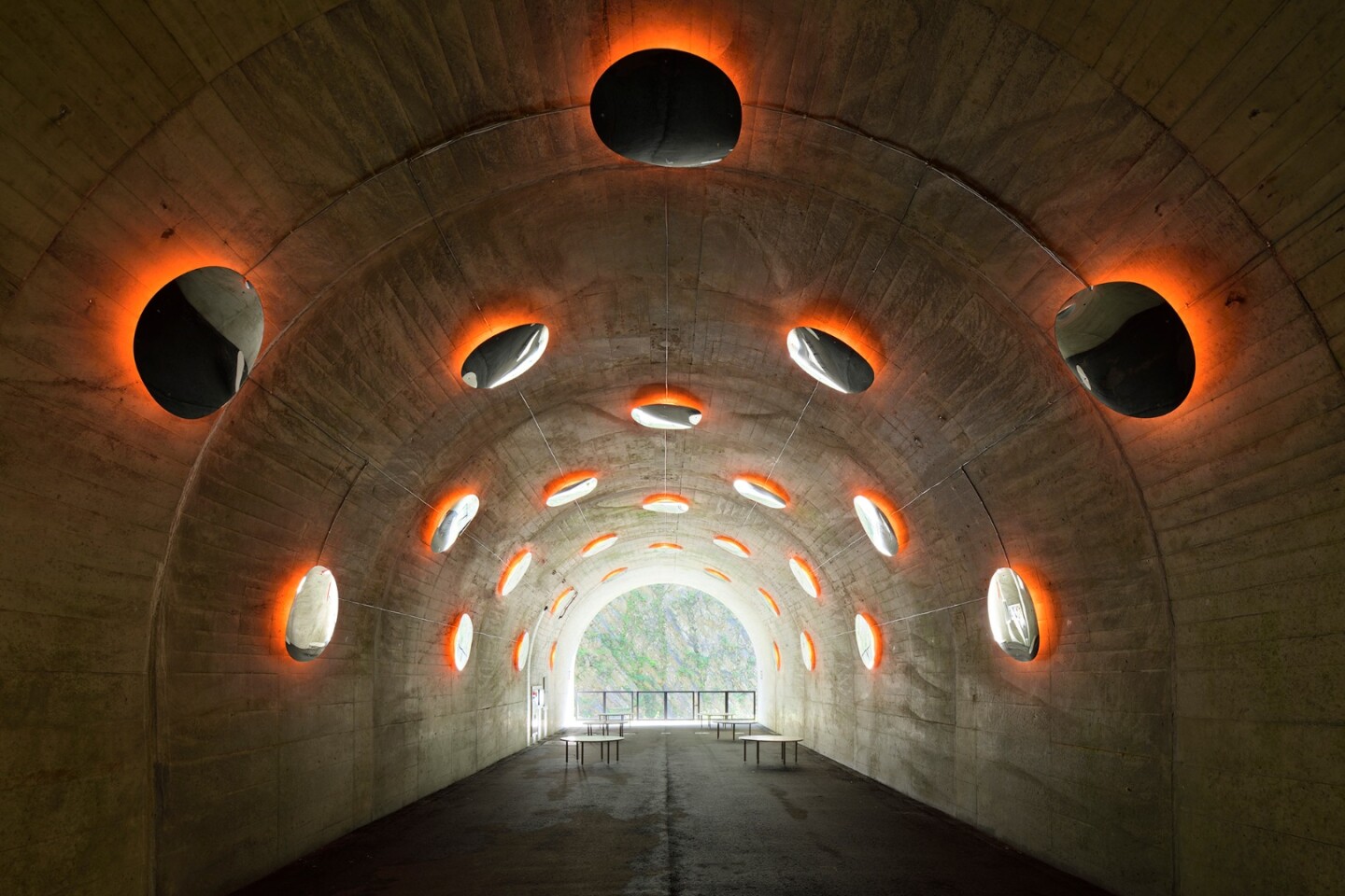 The "Fire" installation at the Kiyotsu Gorge Tunnel features convex mirrors that mimic molten blobs