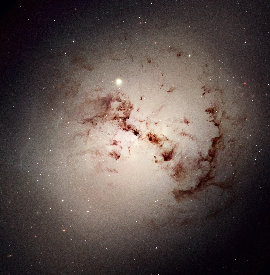 Like dust bunnies that lurk in corners and under beds, surprisingly complex loops and blobs of cosmic dust lie hidden in the giant elliptical galaxy NGC 1316. This image made from data obtained with the NASA/ESA Hubble Space Telescope reveals the dust lanes and star clusters of this giant galaxy that give evidence that it was formed from a past merger of two gas-rich galaxies