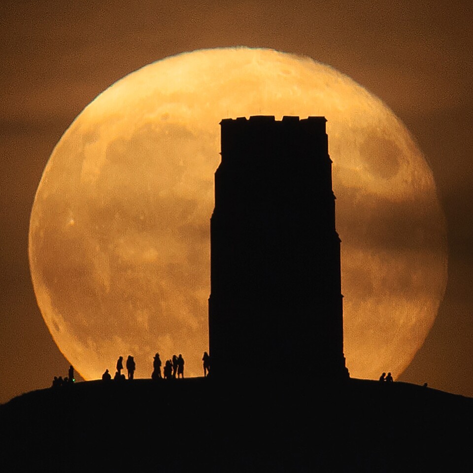 People & Space. Equinox Moon and Glastonbury Tor. A single exposure captures people enjoying the full Harvest Moon rising behind Glastonbury Tor in the United Kingdom in September 2021. Taken with Sigma 150–600 mm telescope, SLIK tripod, Canon EOS 5D Mark II camera, 600 mm f/6.37, 1/8-second exposure