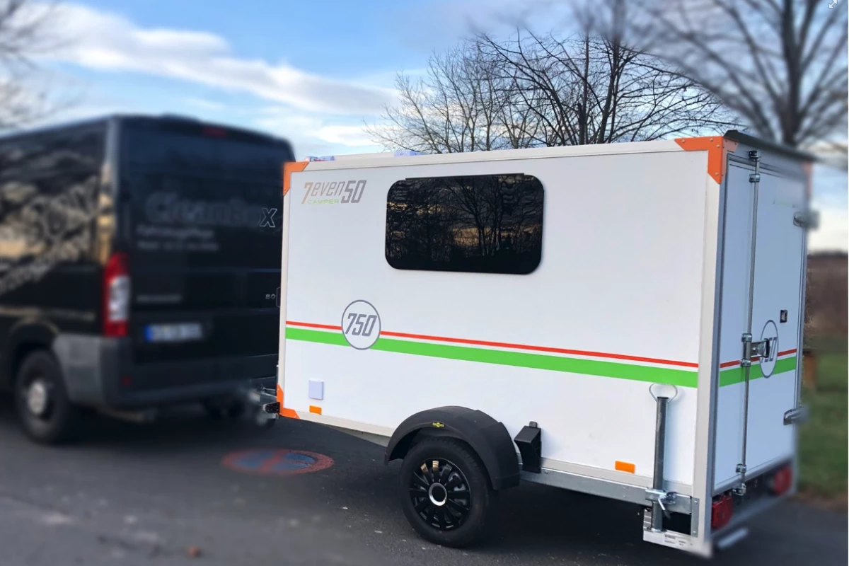 What looks like a basic cargo trailer outside is actually a cozy mini-camper
