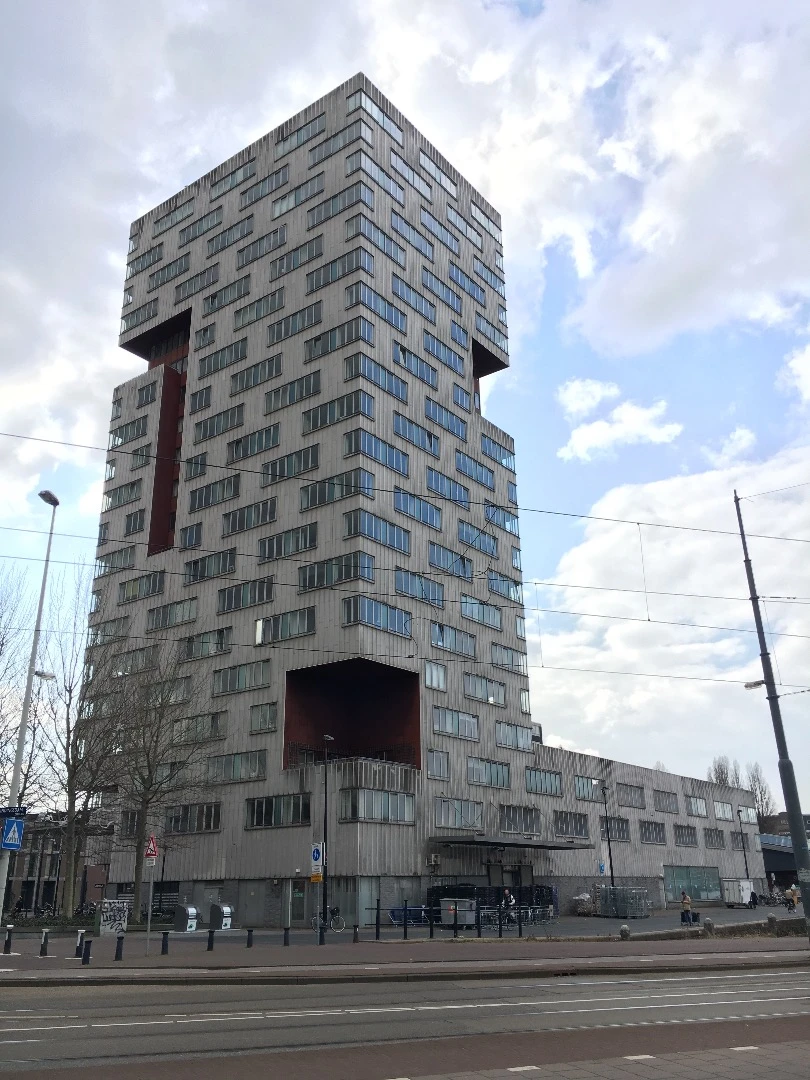 IJ Tower designed by Michiel Riedijk and Willem Jan Neutelings — an apartment building finished in cement and aluminum