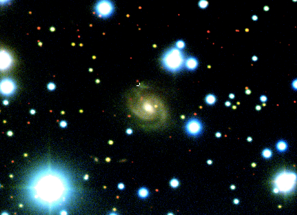 An image from the Gemini North telescope showing the home galaxy of the fast radio burst (white cursor indicates location of the signal)