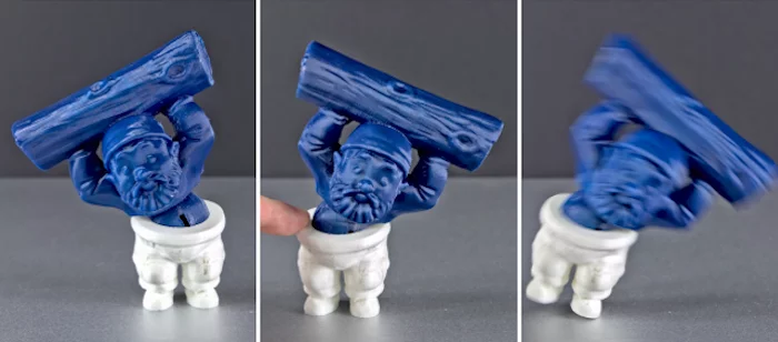 With movable masses embedded inside, the articulated Muscle Gnome figure can stand stably when leaning left, but not when angled to the right