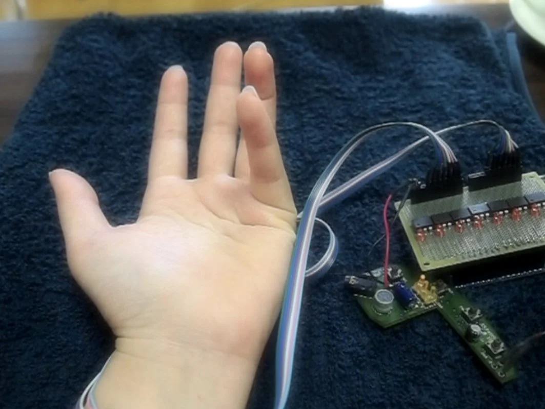 PossessedHand stimulates muscles in the forearm to move a wearer's finger (Photo: Emi Tamaki and Jun Rekimoto / University of Tokyo)