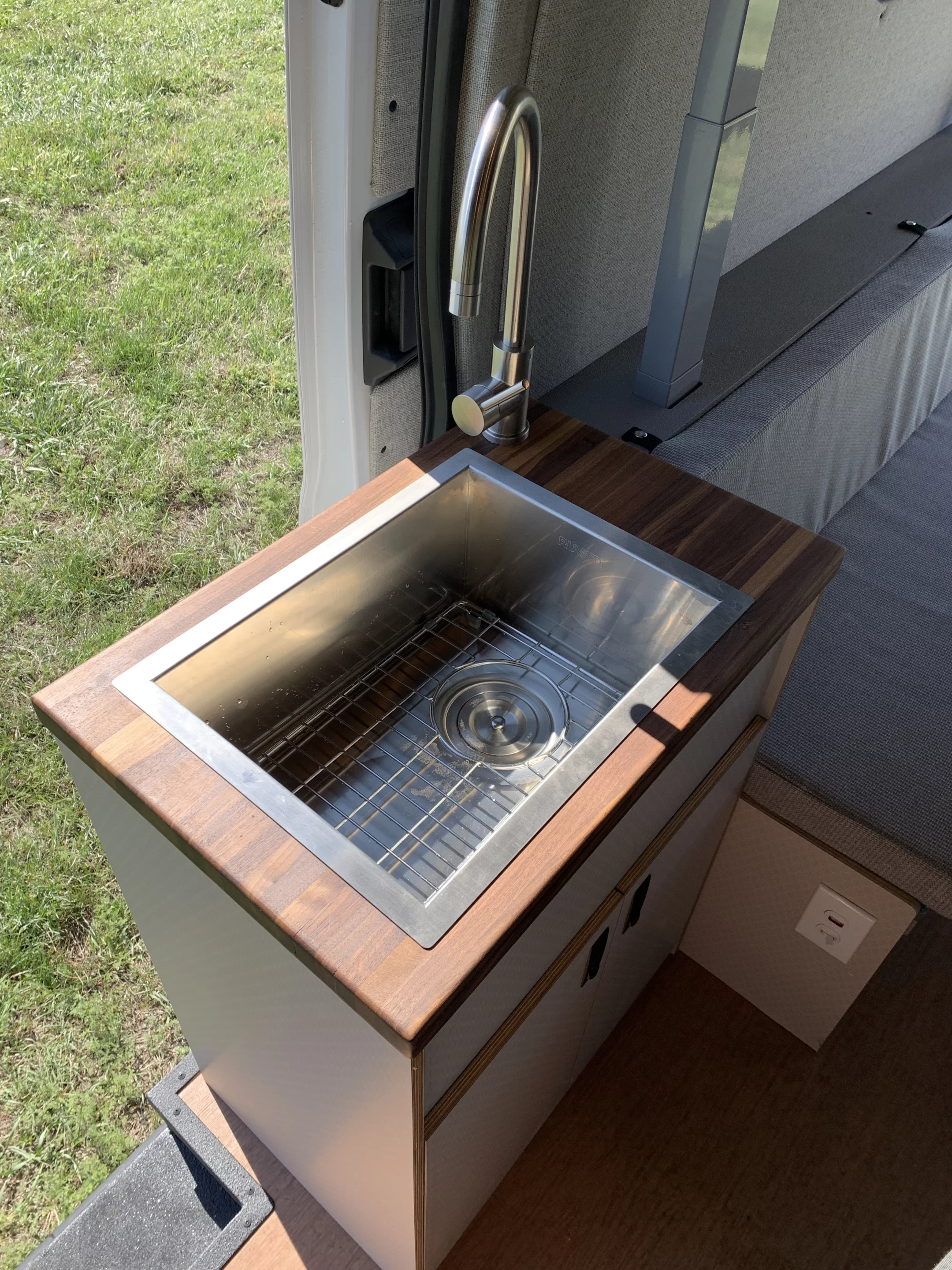 The Base Camp splits its stove and sink into an aisle-straddling kitchen