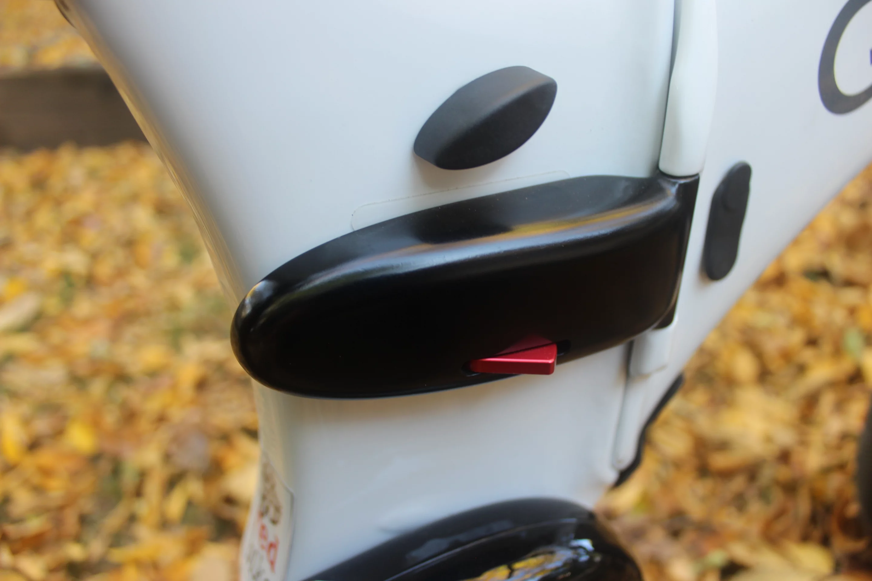 The frame folding latch, with the seatpost thumb screw located above it
