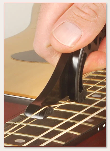 A string is fed through the hook and heel, and then moved up towards the nut and back again