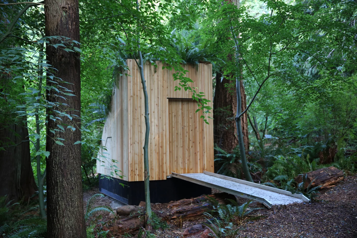 The MycoToilet has a sliding wooden door