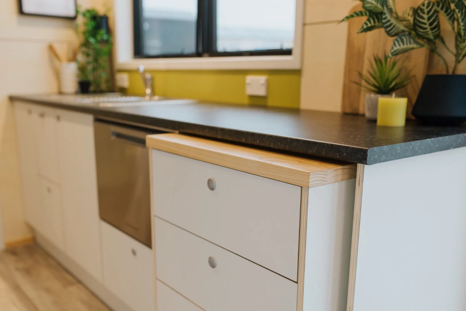 The Green Hill Farm Tiny House's kitchen includes a removable cabinet on wheels