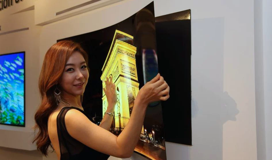 A model peels LG Display's "wallpaper OLED" panel from its magnetic mount