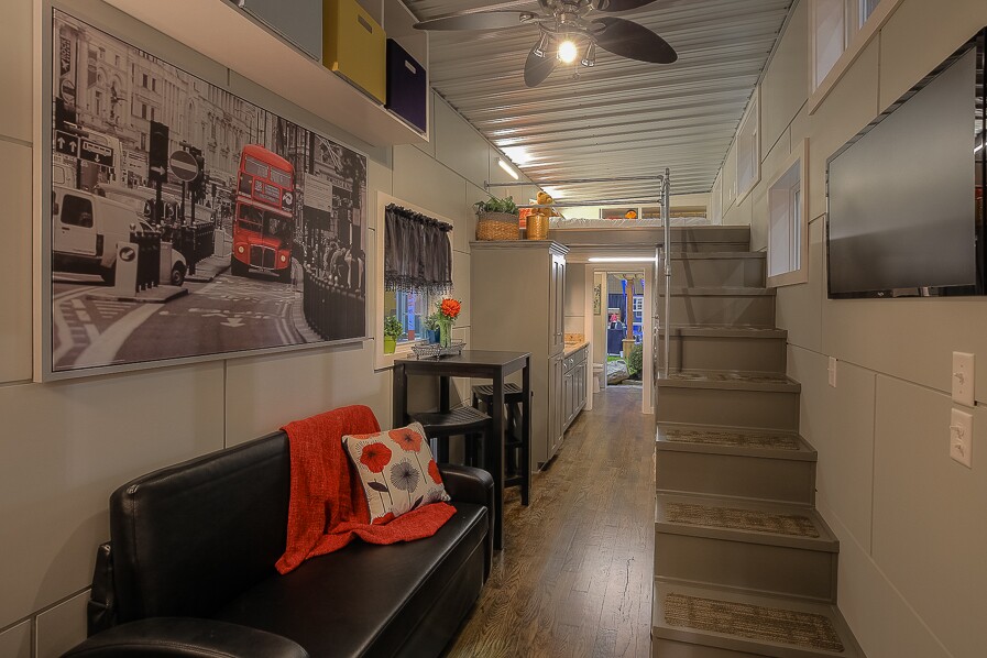 Storage-integrated stairs (with built-in washer/dryer) lead to the loft bedroom