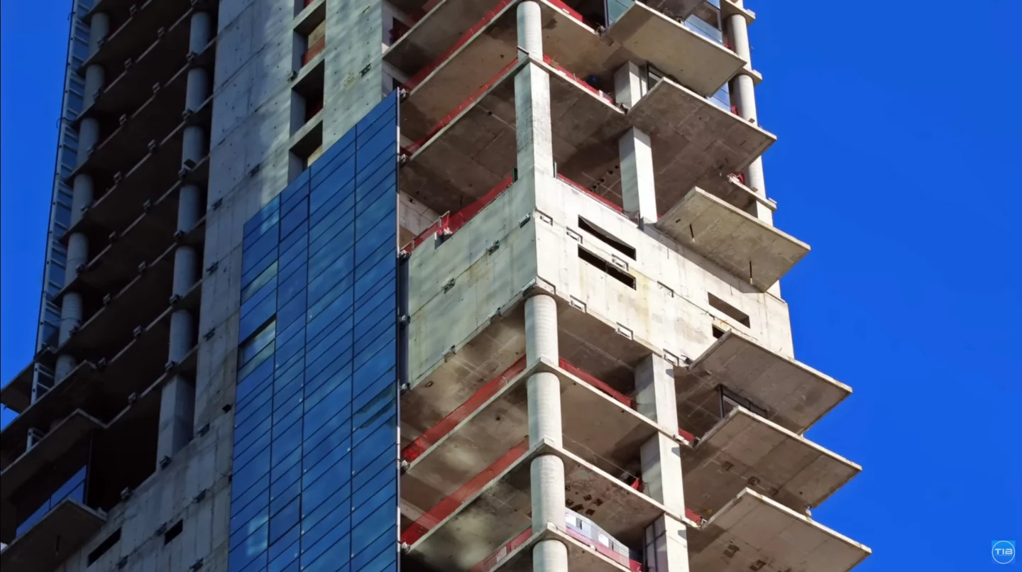 For years the building has stood unfinished, with no completion date in sight – due to its irregular shape and lean, panels from the glass facade have fallen or broken