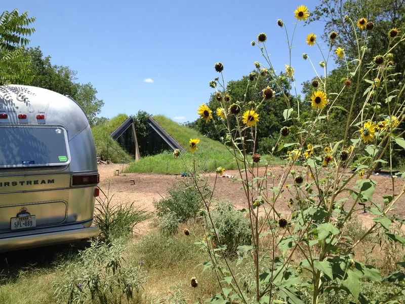 Edgeland House, modeled on the Native American Pit House, is buried 7 ft below ground level and is divided into two clear halves - sleeping and living sectors