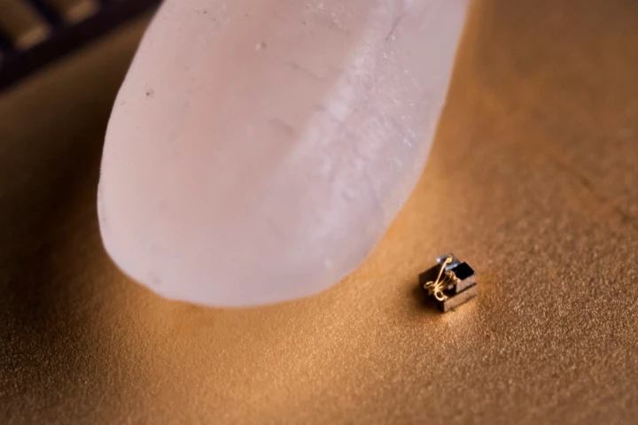 The so-called "world's smallest computer" sitting next to a grain of rice