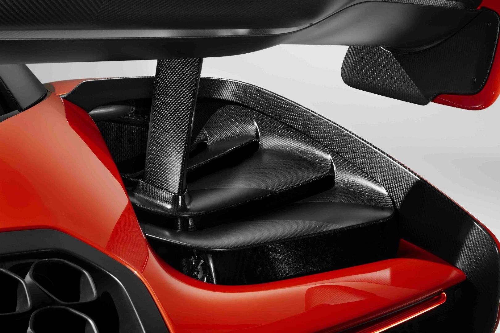 The stepped louvers (pictured) push air along the sides of the car while generating a low-pressure area to draw heat from the engine and radiators