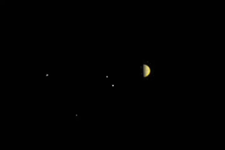 Juno sent this image of Jupiter and its largest four moons as it approaches orbit