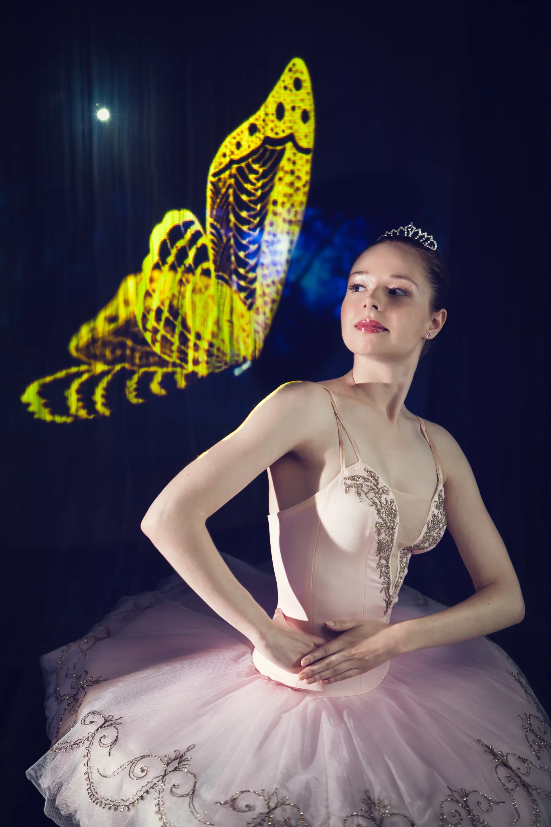 A young woman manipulating the mist and dancing within the display